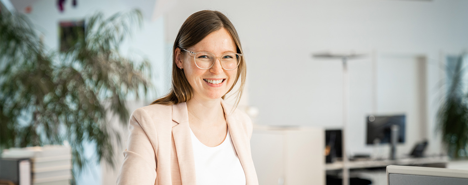Special values have developed from our team spirit. The picture shows a staff member smiling authentically and friendly.