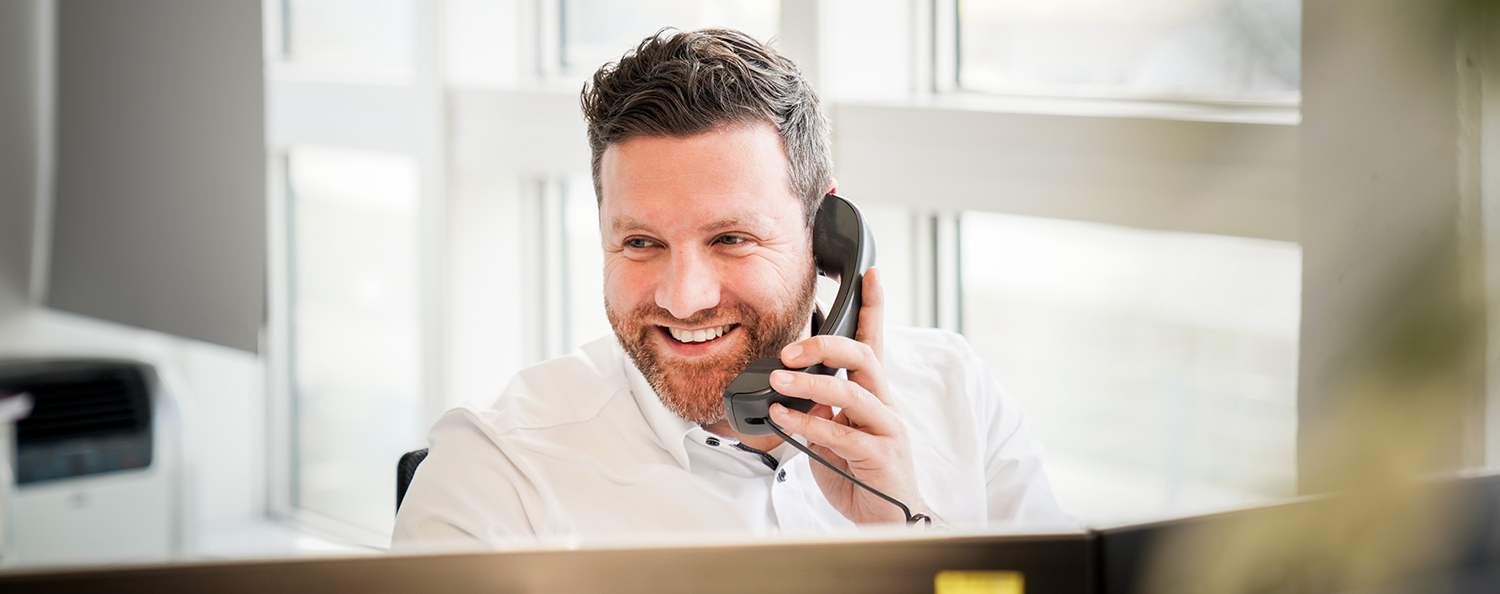 Testo employee laughs and makes a phone call.