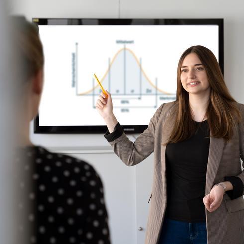 Statistical Process Control (SPC) A woman draws a bell curve